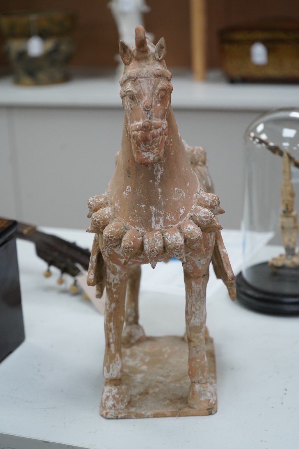A Chinese pottery figure of a horse, Tang dynasty or later, 40cm high